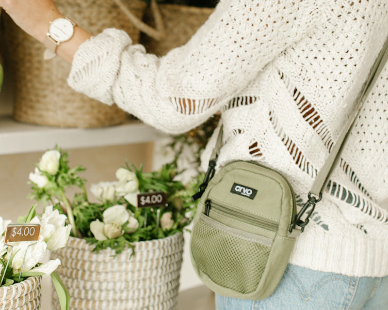 woman shopping carrying a willow green Arvo Fanny