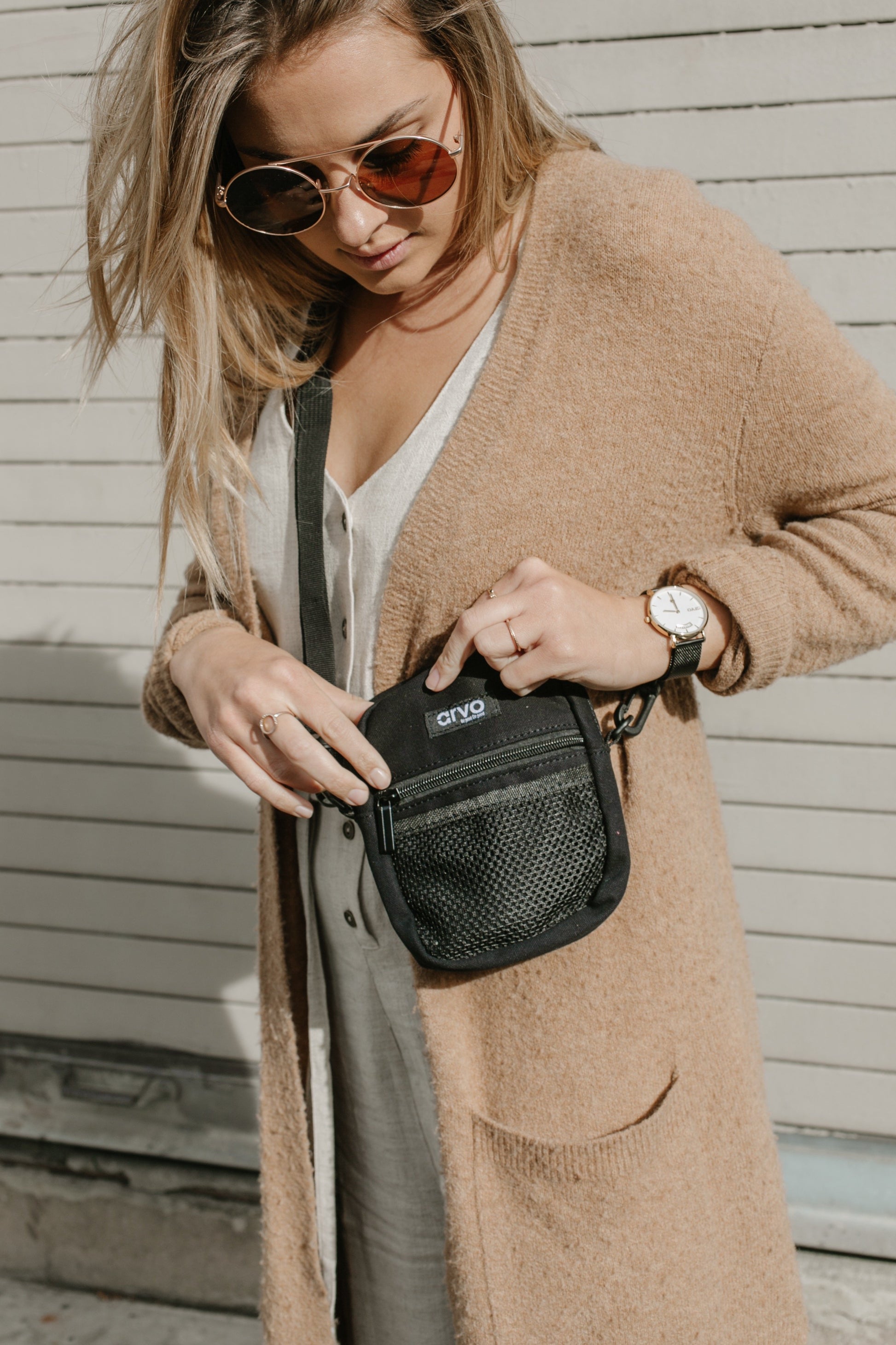 woman in a brown long sweater wearing an Arvo Fanny canvas crossbody bags for women in a pepper black color