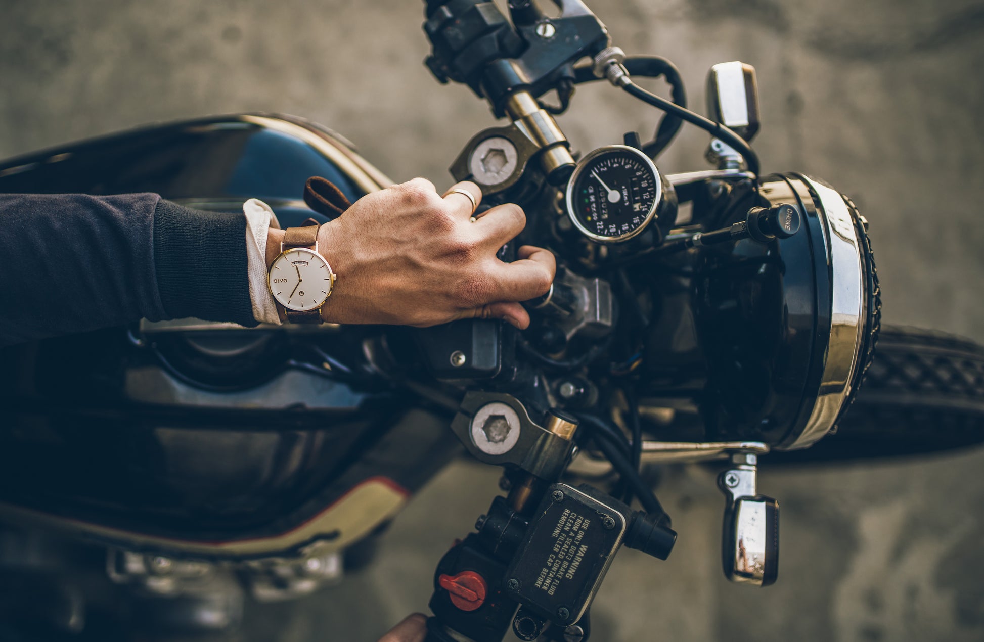 Motorcyclist wearing an Arvo Awristacrat gold watches for women and men with saddle leather band
