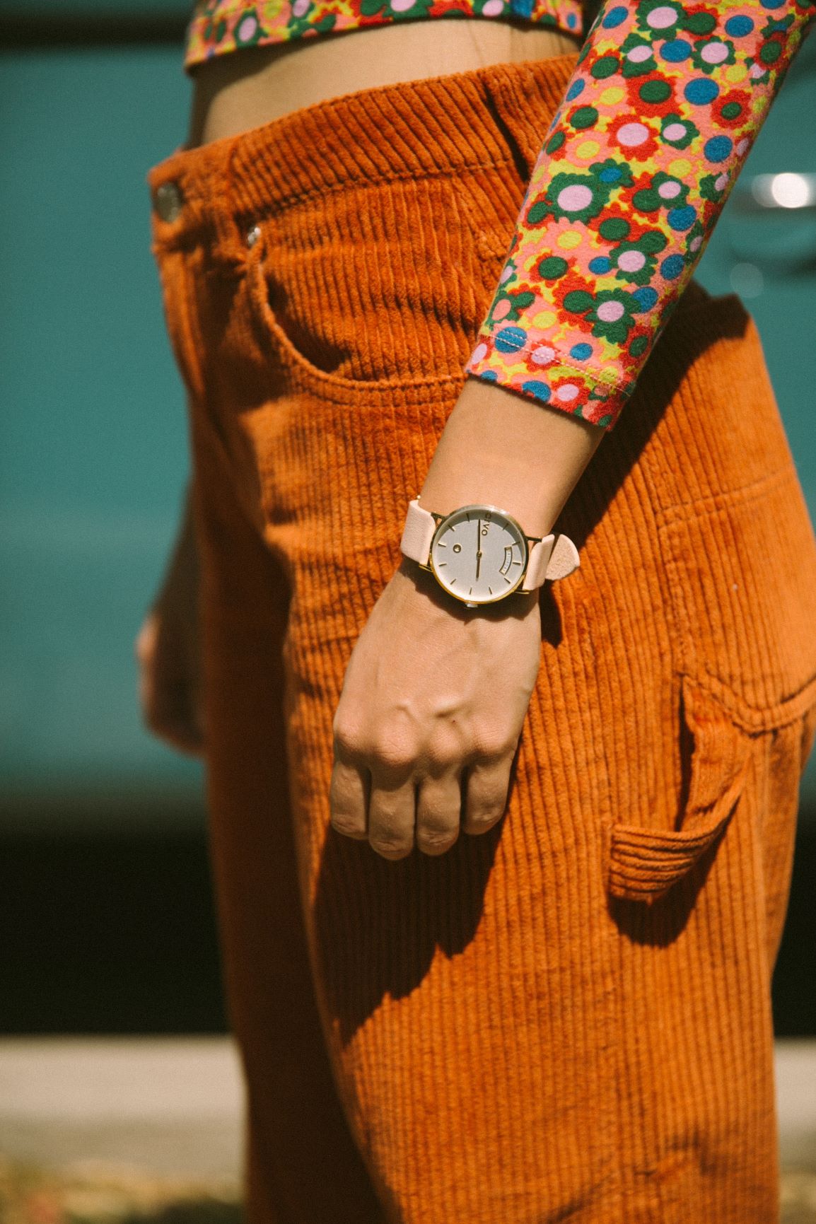 woman standing with arms at her side wearing an Arvo Awristacrat Gold watches for women with white dial, gold case and sand color leather band