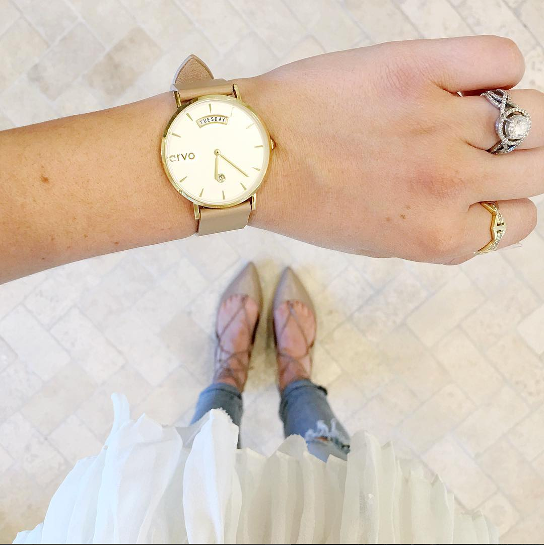 wrist shot of an Arvo Awristacrat gold watches for women with white dial, gold case, and nude or tan leather band