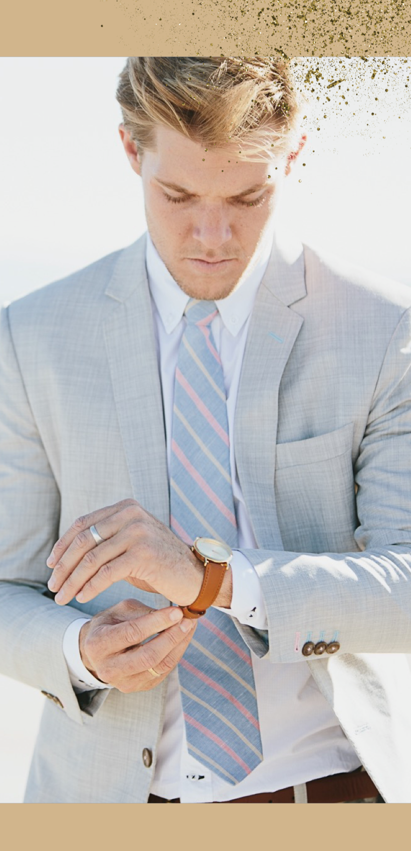 Young man in a light blue suit wearing a Time Sawyer watch for men and women white dial, gold case, and brown leather band