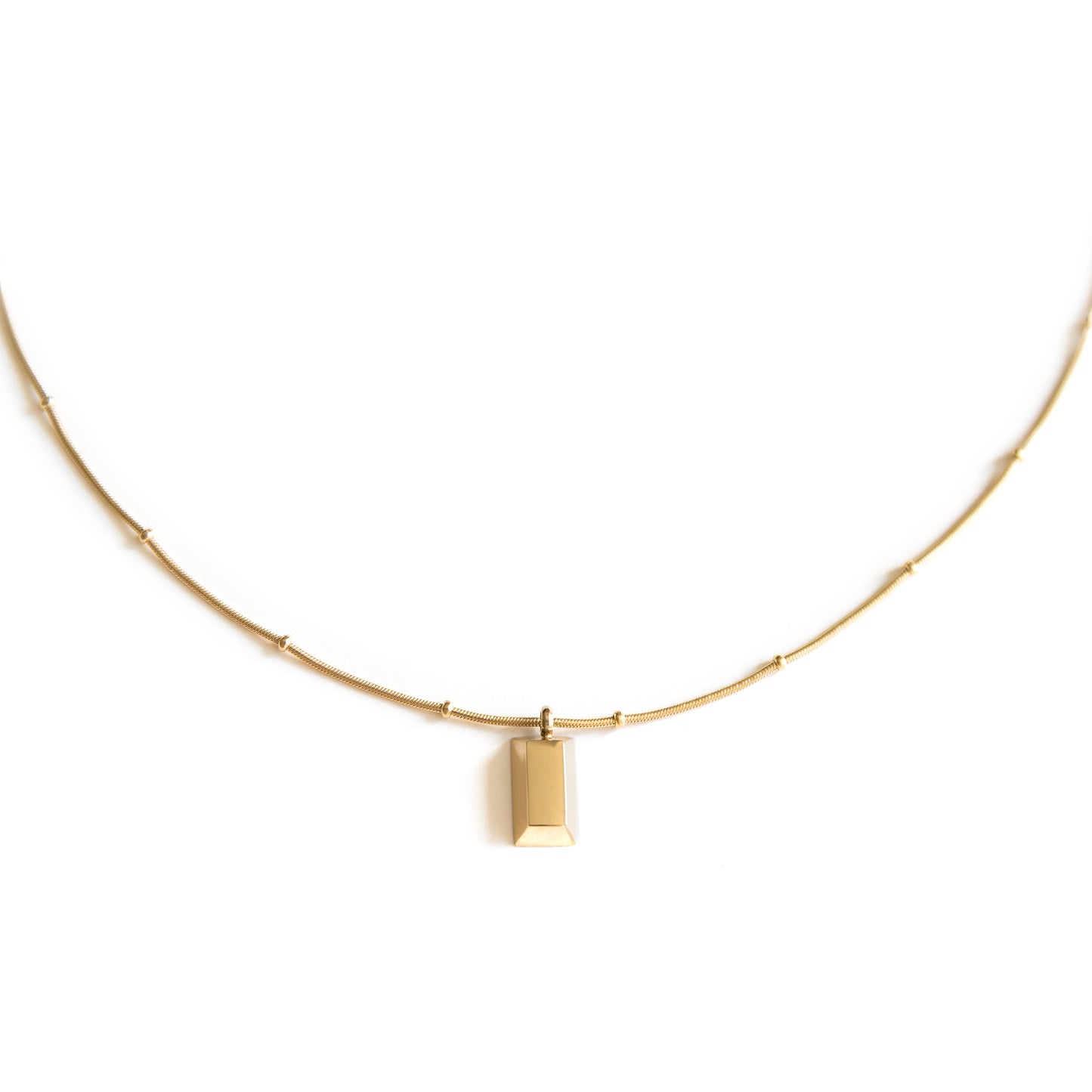 Arvo gold brick on a gold chain necklace on a white background