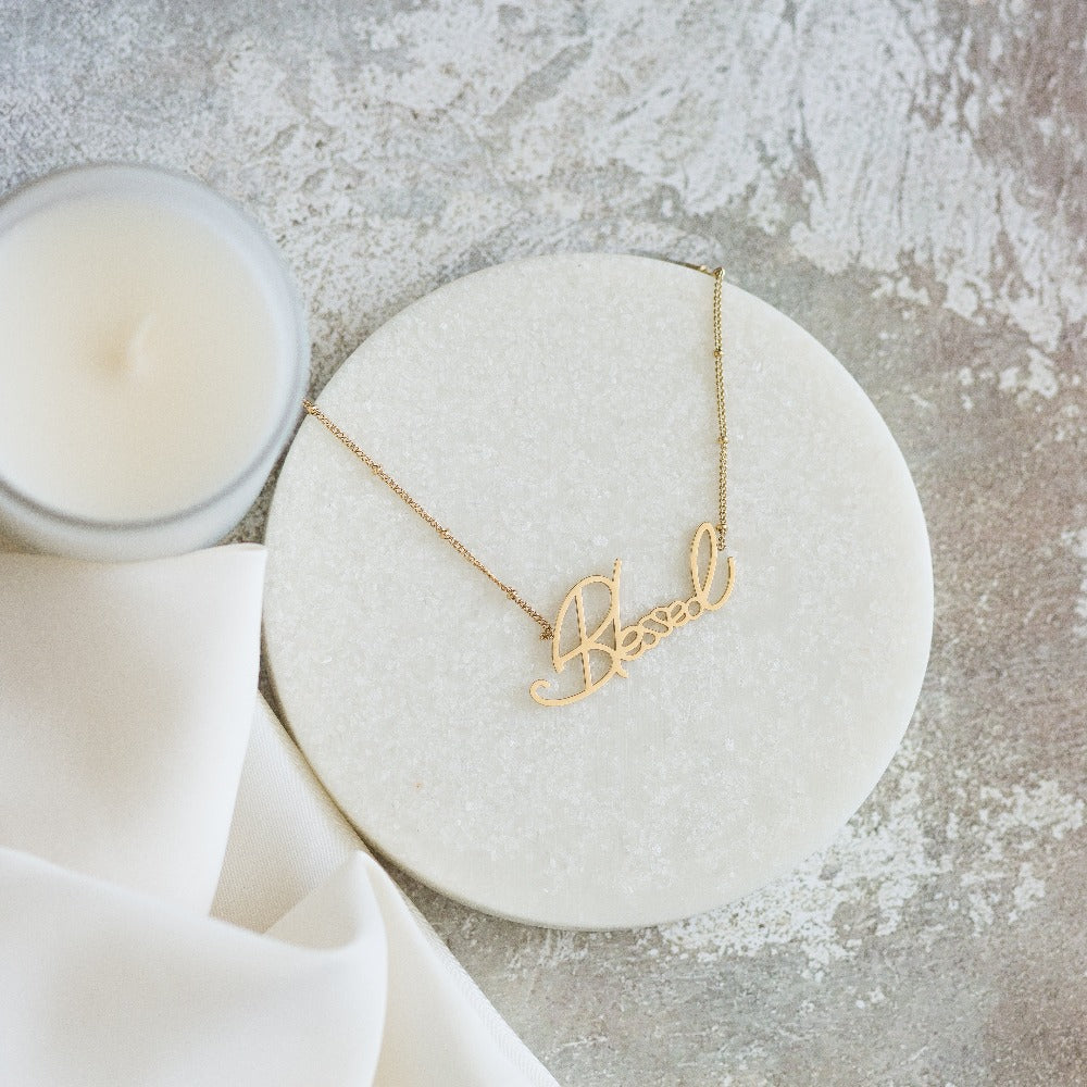 Arvo gold blessed necklace on a white background